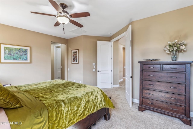 bedroom featuring light colored carpet, ceiling fan, and baseboards