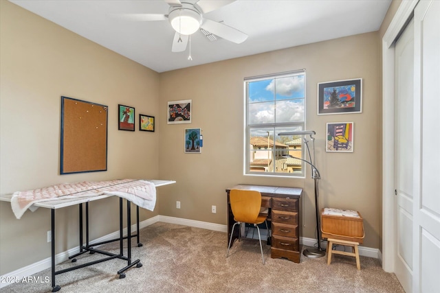 office space featuring ceiling fan, carpet flooring, and baseboards