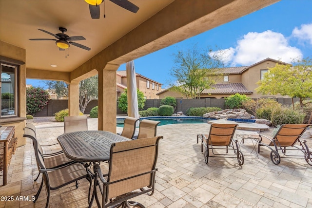 view of patio with a fenced in pool, outdoor dining area, and a fenced backyard