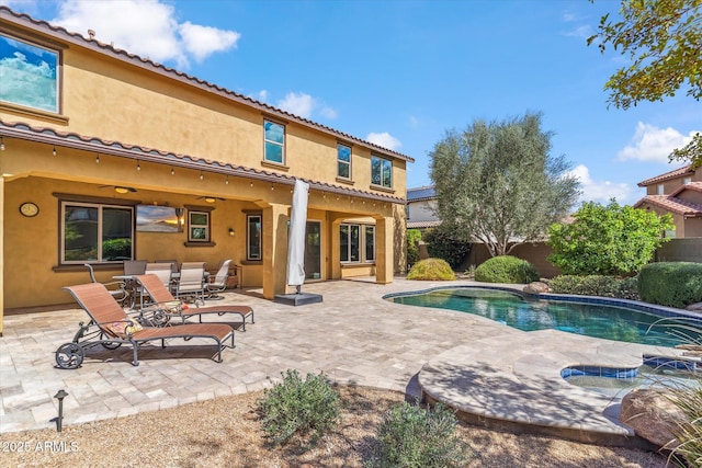 view of swimming pool with a fenced in pool, a fenced backyard, a patio, and ceiling fan