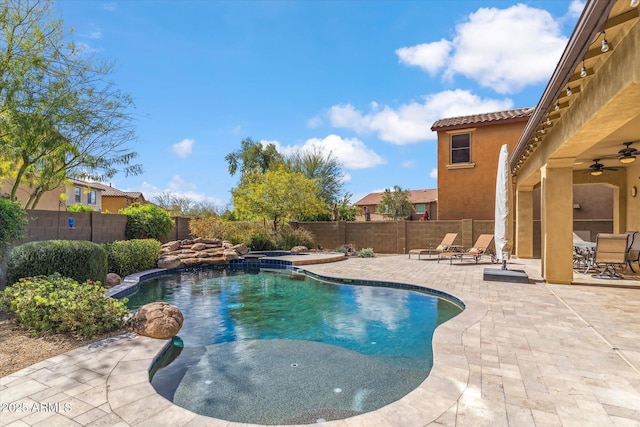 view of swimming pool with a patio area, a fenced backyard, ceiling fan, and a fenced in pool