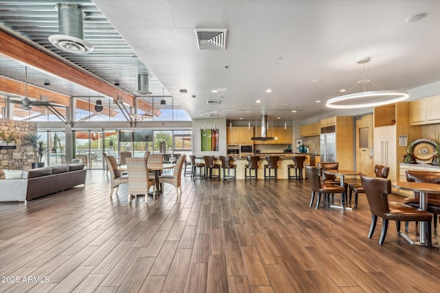 dining space featuring dark wood-style flooring and visible vents