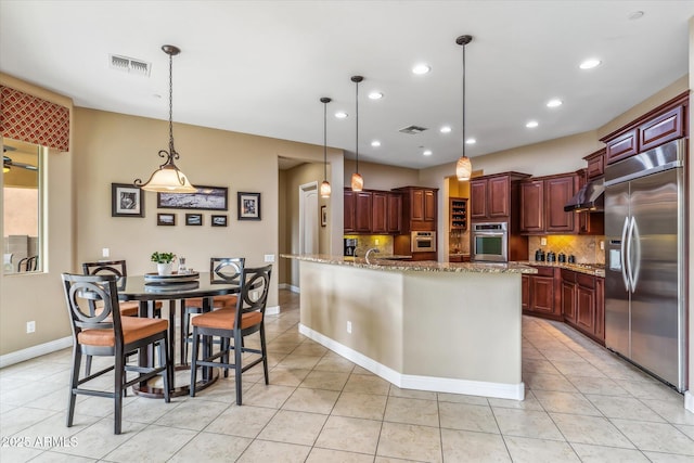 kitchen featuring appliances with stainless steel finishes, under cabinet range hood, visible vents, and backsplash