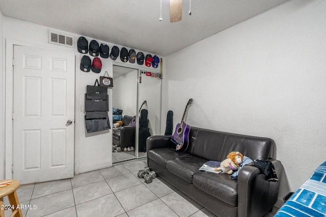 living room with light tile patterned floors, ceiling fan, and visible vents