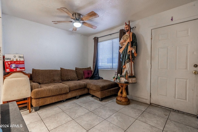 living room featuring a ceiling fan and light tile patterned floors