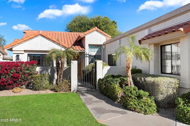 mediterranean / spanish-style house featuring a front lawn