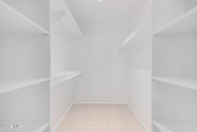 spacious closet featuring light tile patterned flooring