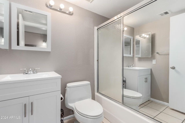 full bathroom featuring bath / shower combo with glass door, toilet, tile patterned floors, and vanity