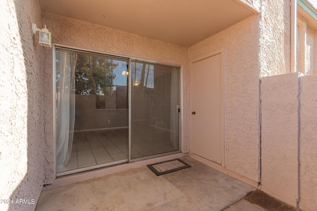 entrance to property featuring a patio