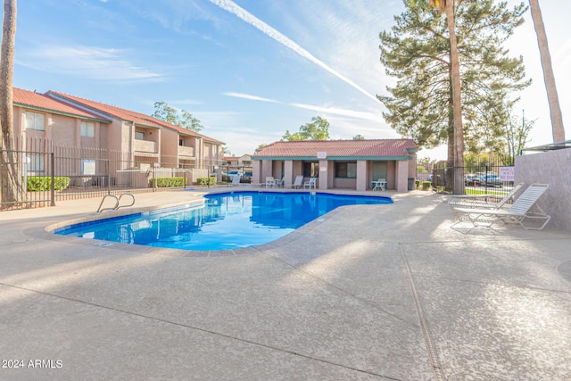 view of pool with an outbuilding and a patio area