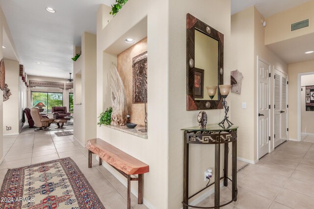 hall with light tile patterned floors