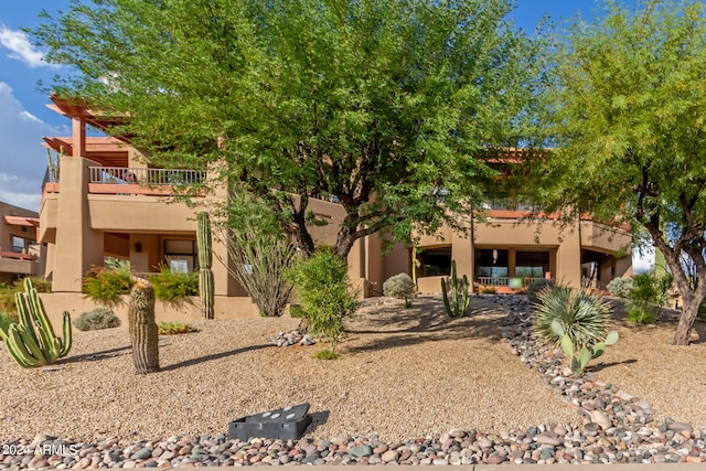 rear view of property featuring a balcony