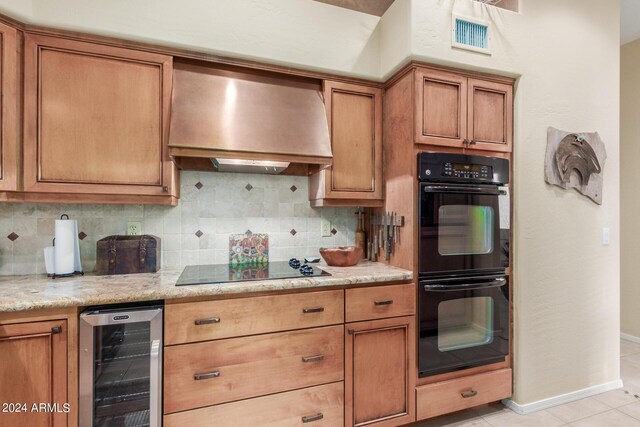 kitchen with backsplash, black appliances, wine cooler, wall chimney exhaust hood, and light stone counters