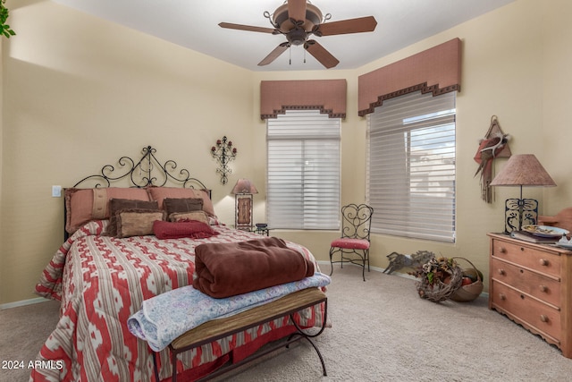 bedroom with ceiling fan and light carpet