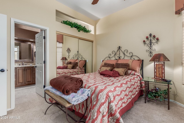 bedroom with light carpet, sink, ceiling fan, connected bathroom, and a closet