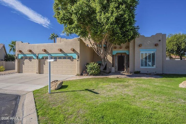 southwest-style home featuring a garage, concrete driveway, a front yard, and stucco siding