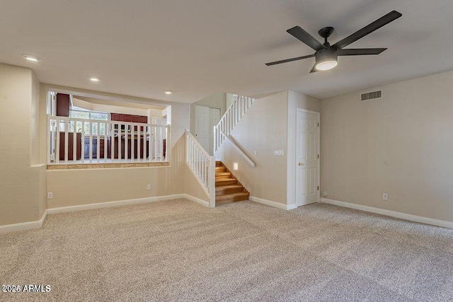 carpeted empty room featuring recessed lighting, visible vents, stairway, a ceiling fan, and baseboards