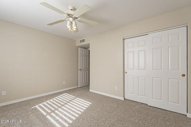 unfurnished bedroom featuring a closet, baseboards, visible vents, and carpet flooring