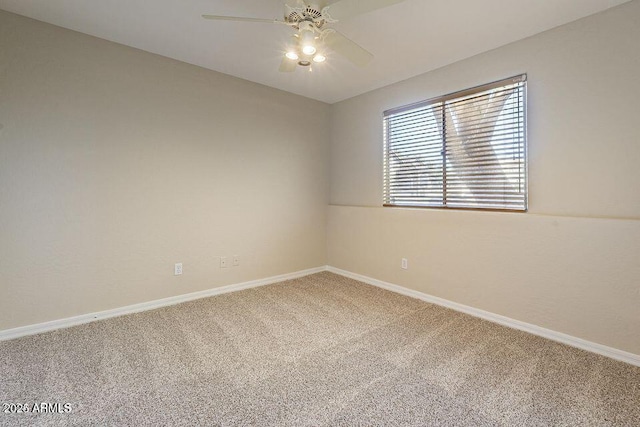 carpeted empty room with a ceiling fan and baseboards