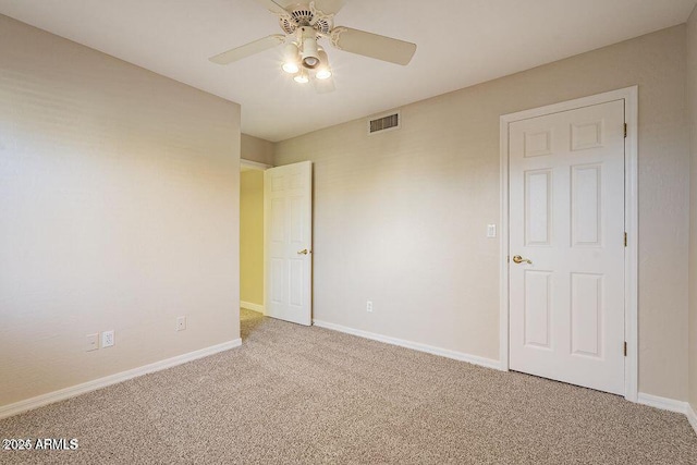 unfurnished bedroom featuring carpet, visible vents, ceiling fan, and baseboards