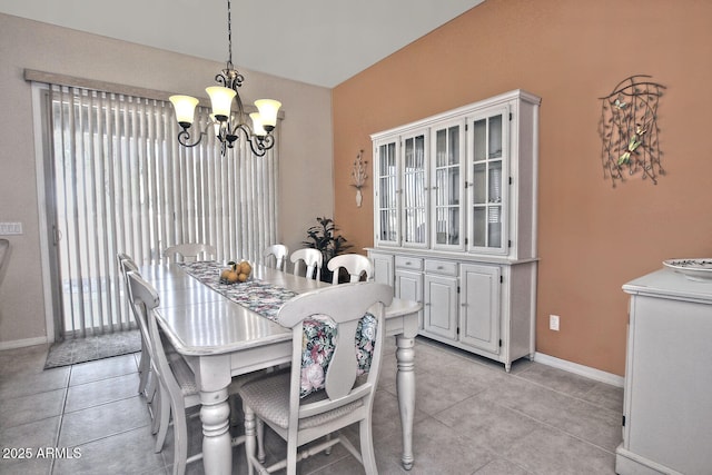 tiled dining space featuring an inviting chandelier