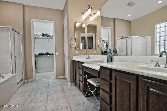 bathroom featuring vanity, tile patterned floors, and a shower with door