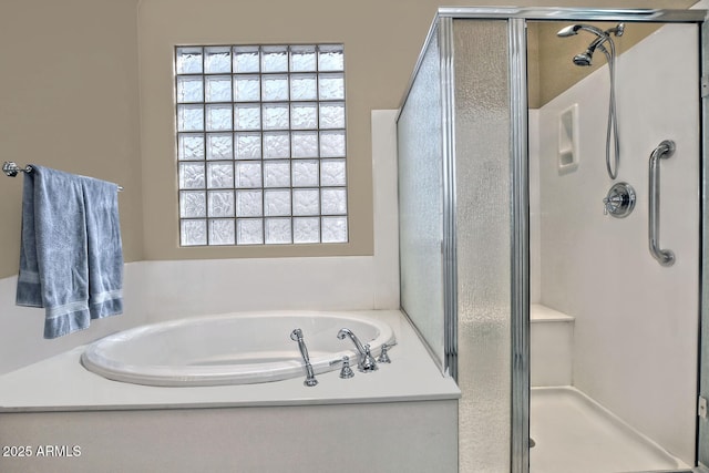 bathroom featuring separate shower and tub