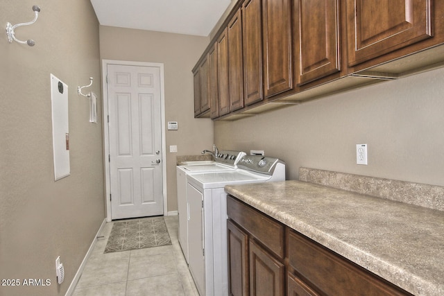 washroom with cabinets, light tile patterned floors, and separate washer and dryer