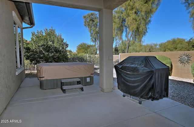 view of patio / terrace featuring a hot tub and grilling area