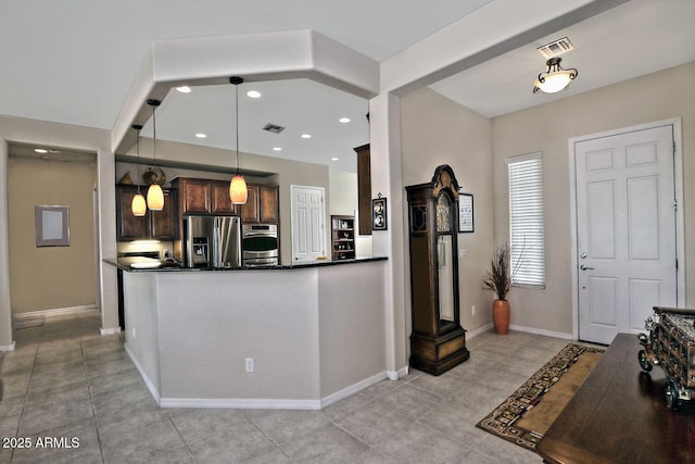 kitchen with dark brown cabinets, kitchen peninsula, stainless steel refrigerator with ice dispenser, and hanging light fixtures