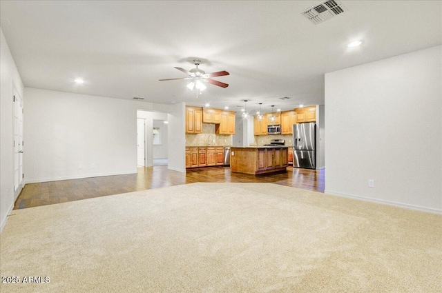 living room with ceiling fan and dark carpet