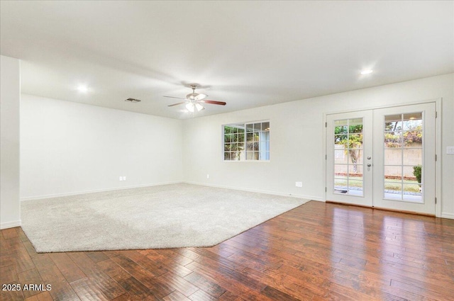 unfurnished room featuring french doors, ceiling fan, and dark wood-type flooring