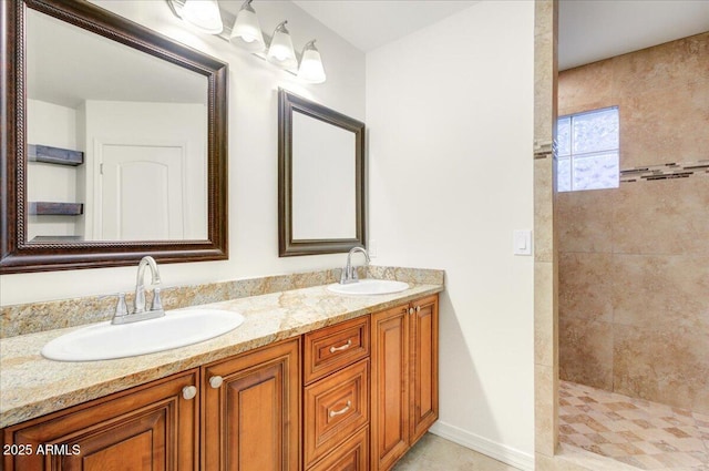 bathroom featuring vanity and tiled shower