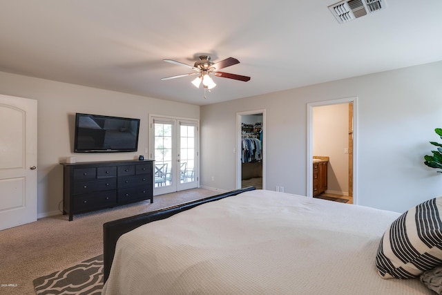 carpeted bedroom with access to outside, french doors, ensuite bath, ceiling fan, and a closet