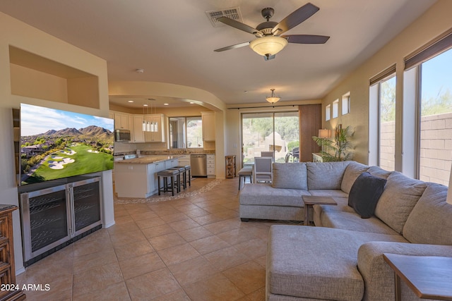 tiled living room with ceiling fan