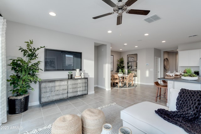 tiled living room featuring ceiling fan