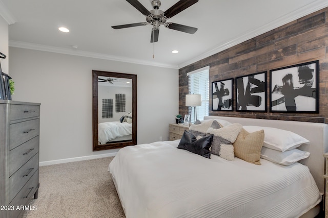 carpeted bedroom with ceiling fan, wood walls, and ornamental molding