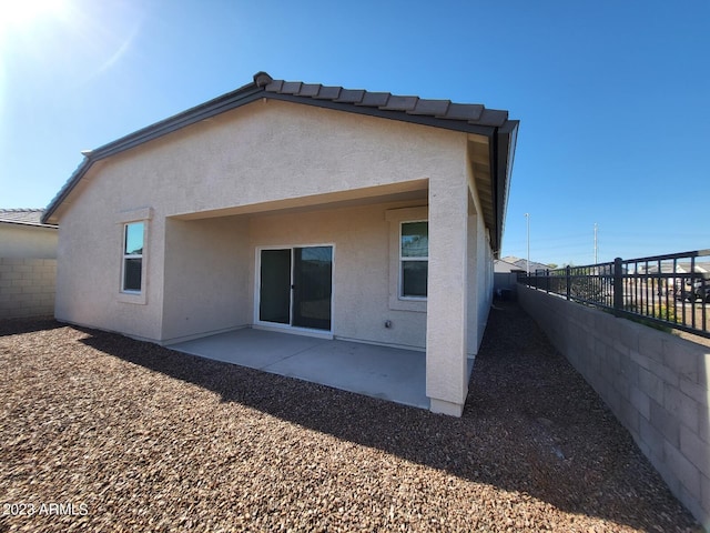 rear view of property featuring a patio