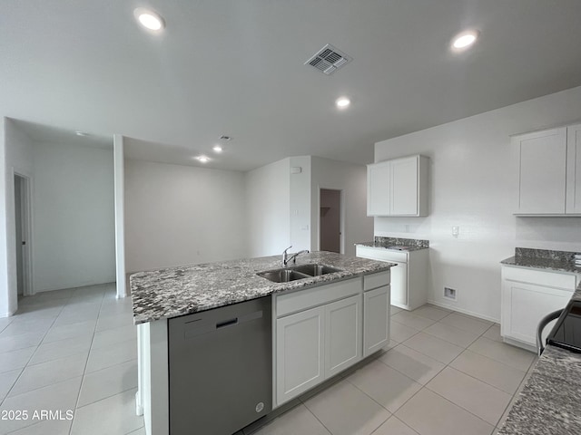 kitchen featuring light tile patterned flooring, white cabinets, sink, dishwasher, and an island with sink