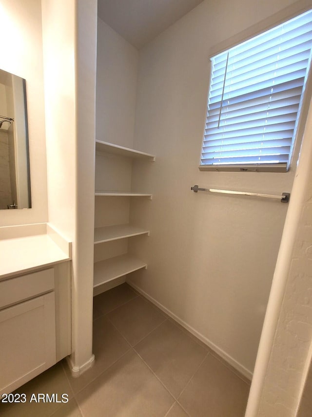 bathroom featuring tile patterned flooring and vanity