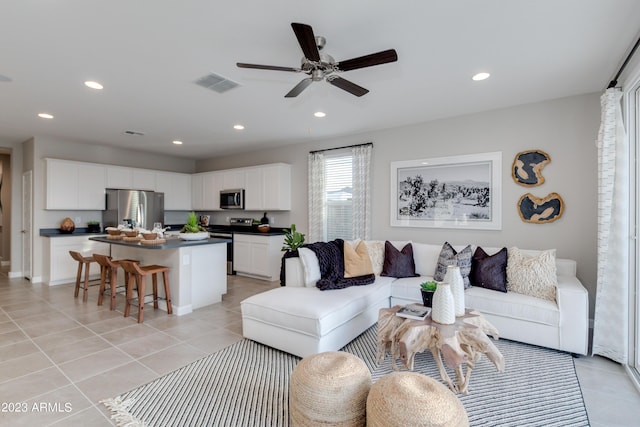 tiled living room featuring ceiling fan