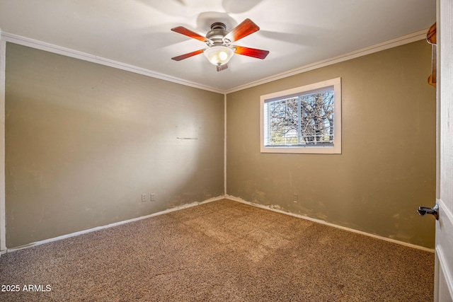 unfurnished room with crown molding, carpet flooring, baseboards, and ceiling fan