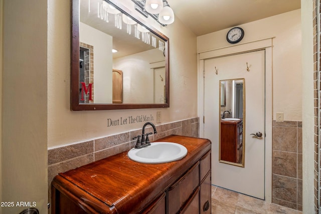 bathroom with tile walls and vanity