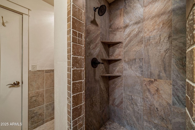 bathroom with tiled shower