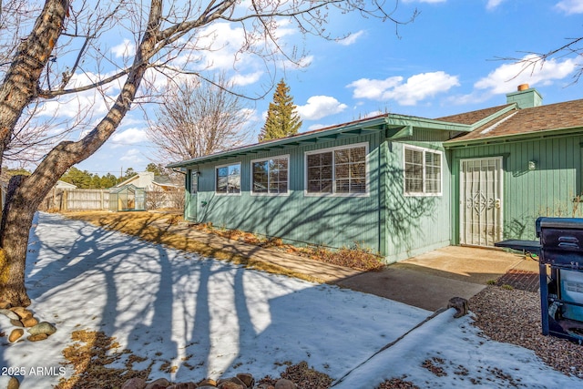 view of side of property featuring fence