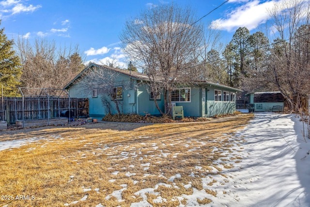 view of front of home featuring fence