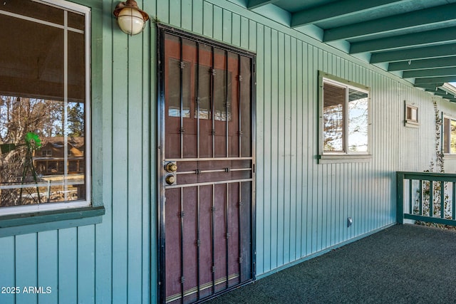 view of exterior entry with board and batten siding