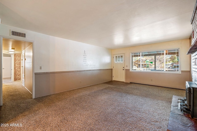 unfurnished living room with visible vents and carpet floors