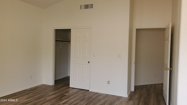 unfurnished bedroom with a closet and dark hardwood / wood-style flooring