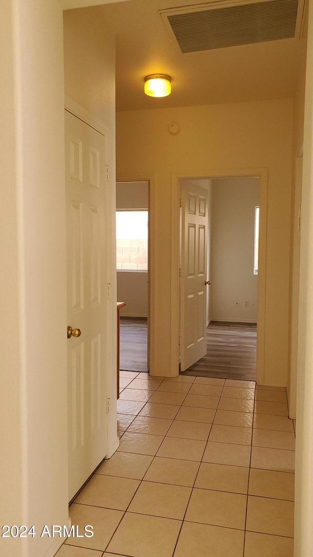 hall with light tile patterned floors